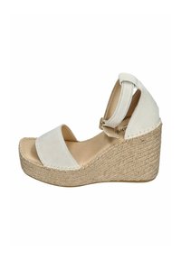 White wedge sandals with suede straps and an espadrille-style jute sole. Features an adjustable ankle strap and a smooth texture.