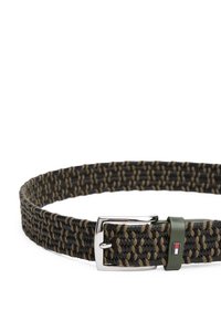 Woven belt in black and olive green with a silver metal buckle. Features a textured finish and a small logo accent on the strap.