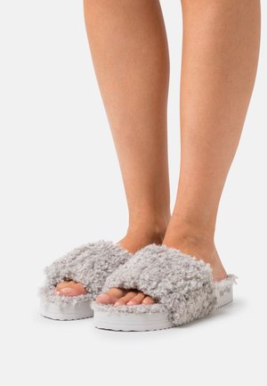 Gray, fluffy slide sandals with a soft texture and white rubber sole. Two wide straps cover the top of the foot. Open-toe design.