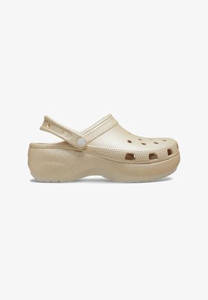 Beige Glitzerclogs mit offener Zehenpartie, Riemen hinten und Belüftungsöffnungen. Hergestellt aus leichtem Material mit strukturierter Oberfläche.