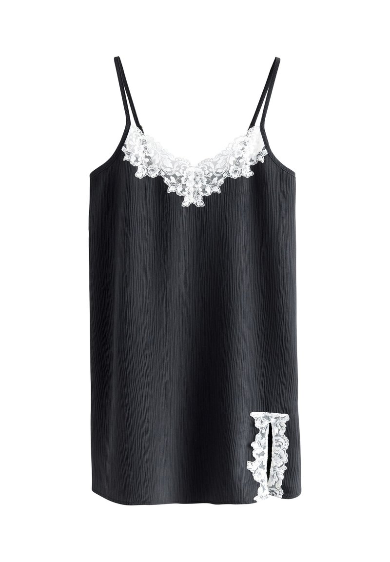 Robe noire sans manches en tissu texturé, ornée d'un bord en dentelle blanche le long de l'encolure et d'un détail en dentelle sur le côté.