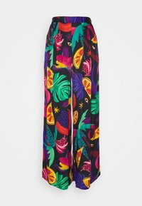 Pantalons larges avec un imprimé tropical vibrant comprenant des feuilles colorées, des fleurs et des tranches d'agrumes sur un fond noir.