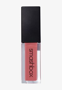 Liquid lipstick in a rectangular clear glass tube with a pink hue, topped with a smooth black square cap. Features the brand name "Smashbox."