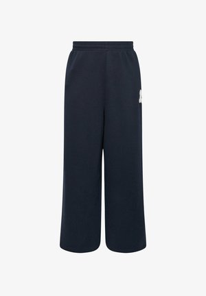 Pantalons de survêtement bleu marine en coton doux, dotés d'une taille élastique et d'une coupe large avec un petit logo sur le côté.