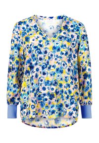 Bloemige blouse met een V-hals, lange mouwen, blauwe accenten en een kleurrijke print met blauwe, gele en roze bloemen op een lichte achtergrond.
