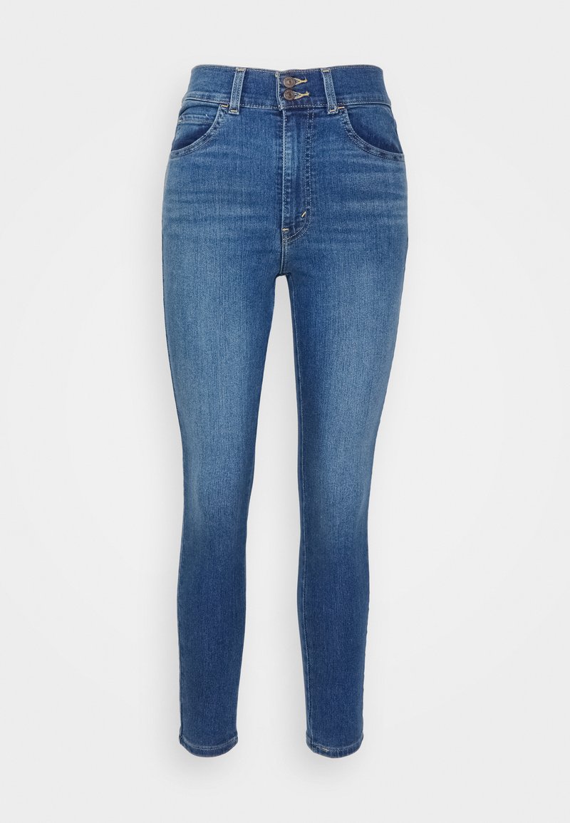 Jeans skinny in denim blu medio, a vita alta, con due tasche anteriori e una chiusura lampo con due bottoni. Tessuto liscio e minima sbiaditura.