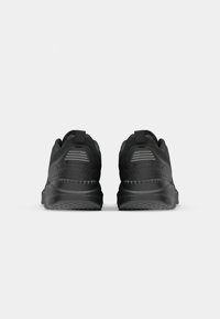 Black athletic shoes with a textured mesh upper, padded heel, and rubber sole. Features minimal branding and subtle reflective stripes.