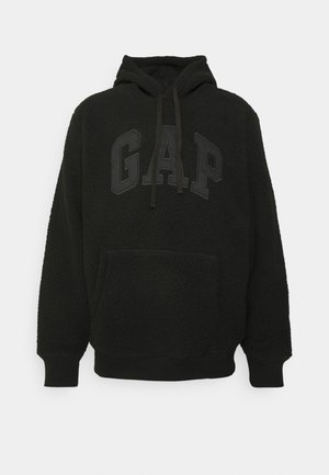 Felpa nera in pile con tasca a marsupio, cappuccio regolabile e logo GAP in gomma. I polsini e l'orlo ribattuti garantiscono una vestibilità aderente.