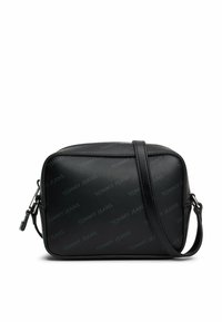 Bolso cruzado sintético negro con el logotipo en relieve "TOMMY JEANS", forma rectangular, correa ajustable y herrajes de cremallera en tono plateado.