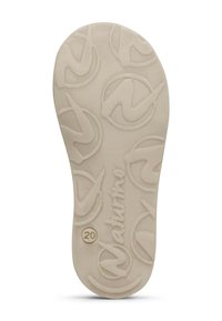 Suola di una scarpa in beige chiaro con una superficie testurizzata caratterizzata da un motivo a logo e design circolari, contrassegnata con un "20" sul lato.