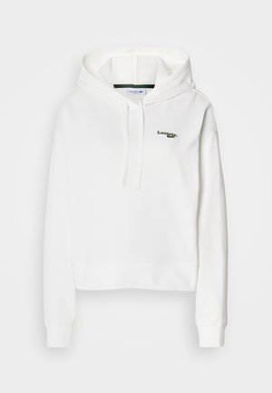 Bela kapuca iz mehkega materiala z kenguru žepom, kapuco s vezalkami in zelenim vezenim logotipom na prsih. Ima rebraste manšete.