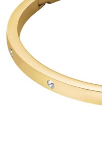 Gold bangle bracelet with a smooth, rounded design featuring three small, embedded clear gemstones along the band for accent.