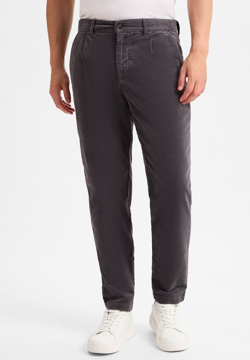 Gray cotton chinos with a slight textured finish, featuring a button closure and side pockets, paired with white sneakers.