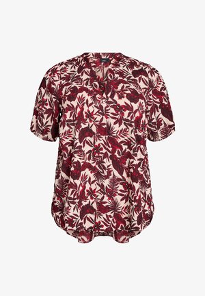 Kreemjas lillelises pluusis on punased ja tumepunased lehemustrid, lühikesed varrukad, V-kaelus ning lõdvestatud soejoon ja kumer äär.