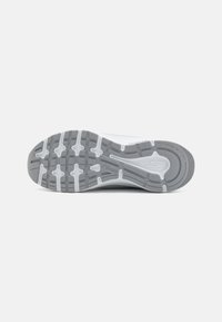 Athletic shoe outsole in grey and white rubber, featuring multidirectional tread patterns and branding detail on the side.