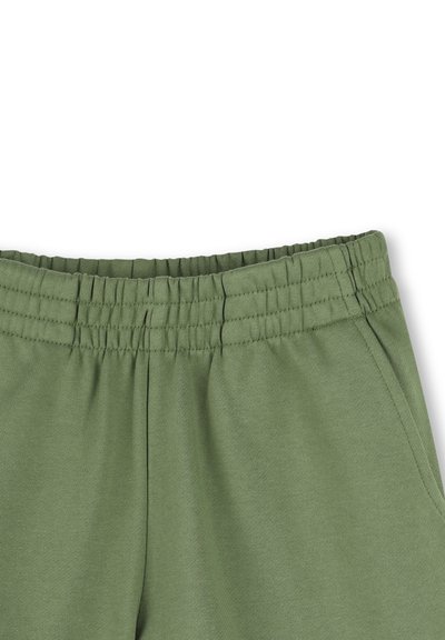 Groene katoenen joggers met een elastische tailleband, voorzien van zijzakken en een zachte, gladde textuur. Geen patronen of decoraties.