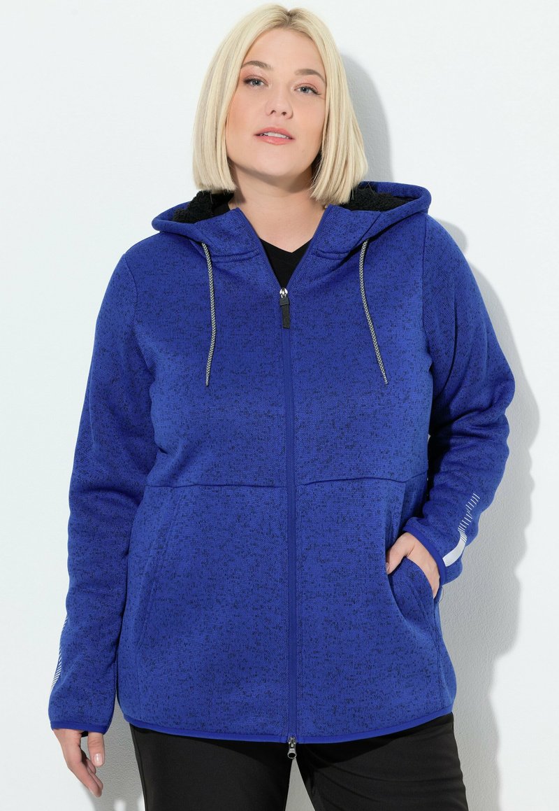 Felpa con zip di un blu reale in tessuto testurizzato; presenta un cappuccio foderato, due tasche anteriori e dettagli con lacci.