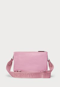 Pink leather crossbody bag with a flat design. Features a smooth texture and a wide strap embossed with the brand name. Zipper closure at top.