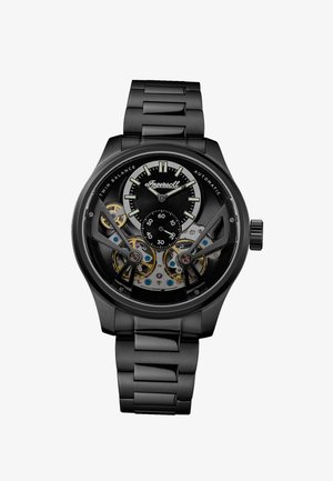Black metal automatic wristwatch with visible twin balance gears, luminous hands, small seconds dial, and Ingersoll branding on face.