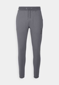 Mørkegrå tapered sweatpants med elastisk talje, snoretræk og subtil "SIKS 89" tekst på den øvre lår.
