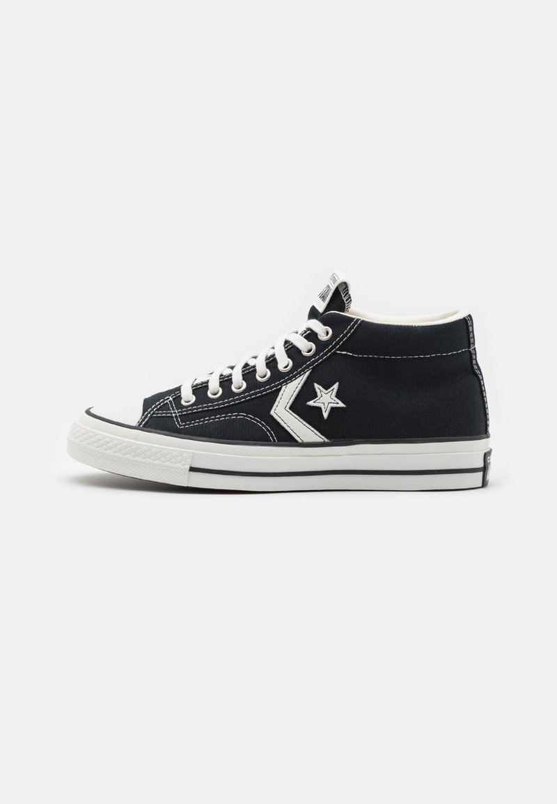 Black high-top sneaker with white laces, white rubber sole, and a white star logo on the side, on a plain white background.