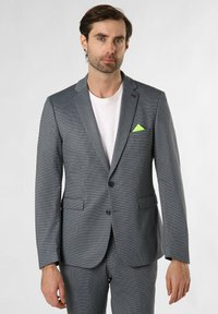 Grau gemusterter Blazer mit schlanker Passform, featuring einem Revers, zwei Fronttaschen und einem leuchtend grünen Taschentuch.