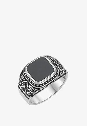 Silberner Ring mit einem eingravierten, komplizierten Muster und einem großen schwarzen rechteckigen Stein in der Mitte.