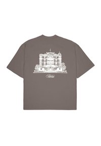 Brown cotton T-shirt featuring a white illustration of an architectural building with trees. Short sleeves and a crew neckline.
