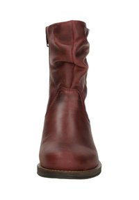 Red leather ankle boot with a slouchy design, rounded toe, and minimal stitching. Features a side zipper and a flat sole.