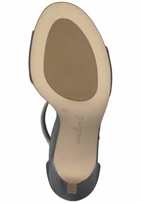 Sandal in pelle nera con punta tondeggiante, cinturino slingback e suola in gomma beige. Presenta un logo brandizzato sulla soletta.