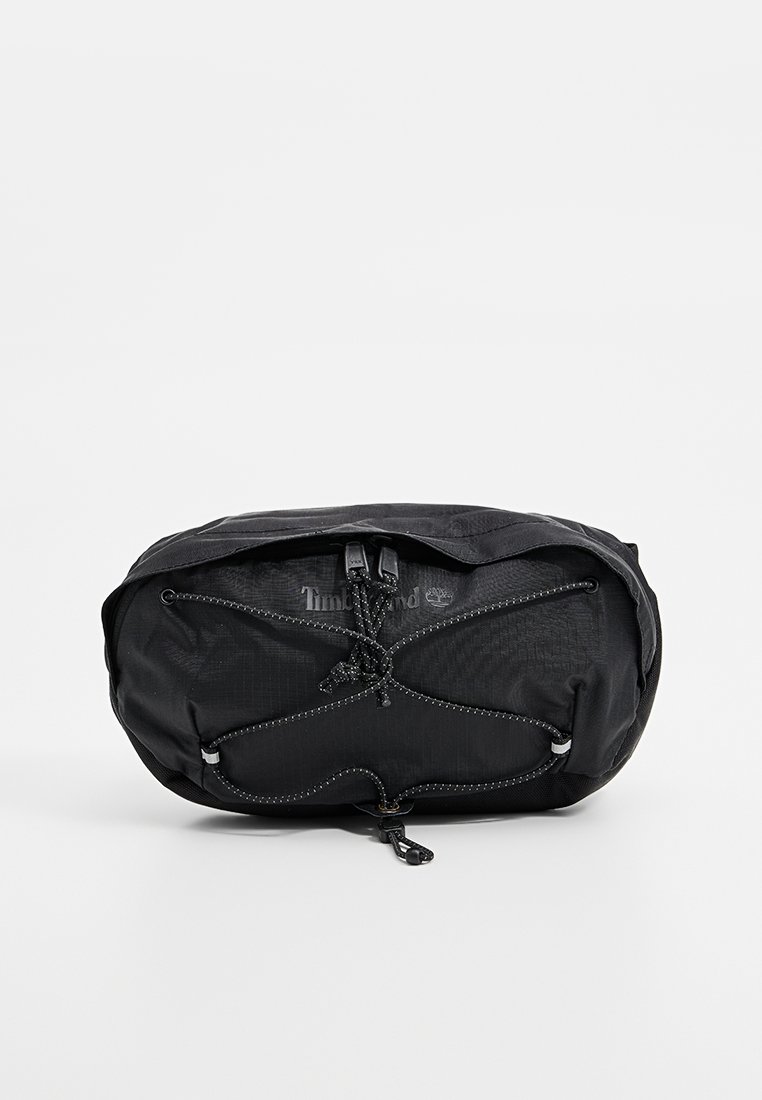 Sac en nylon noir au design élégant, avec une fermeture à cordon élastique et une surface texturée, arborant un logo Timberland.