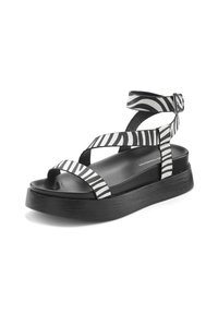 Black platform sandals featuring wide, crisscross straps in a bold white zebra stripe pattern. Smooth texture with a textured base.