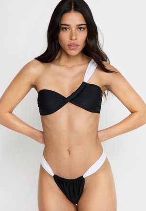 Black and white bikini set featuring a twist bandeau top with one shoulder strap and high-cut bottoms with a gathered side accent.