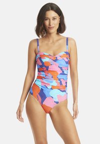 Maillot de bain une pièce multicolore avec un décolleté en cœur, des bretelles réglables et des détails froncés. Présente des motifs abstraits vibrants bleus, roses et oranges.