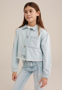 Light blue denim jacket with a cropped design, front buttons, a chest pocket, and frayed hem. Paired with matching light blue jeans.