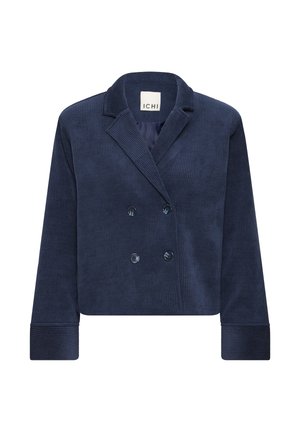 Tamsiai mėlynas kordurovinis trumpintas švarkas, kurio dizainas su dviguba sagų eilute, su įpjautomis atvartomis ir didelėmis sagomis. Rankovių ir kūno dalyje matyti briaunuota tekstūra.