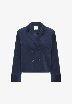 Výstrihnutý módny blejzer z námorníckeho manšestru, zdobený dvojradovým zapínaním, vyrážanými klopami a veľkými gombíkmi. Žíhaná textúra na rukávoch a tele.