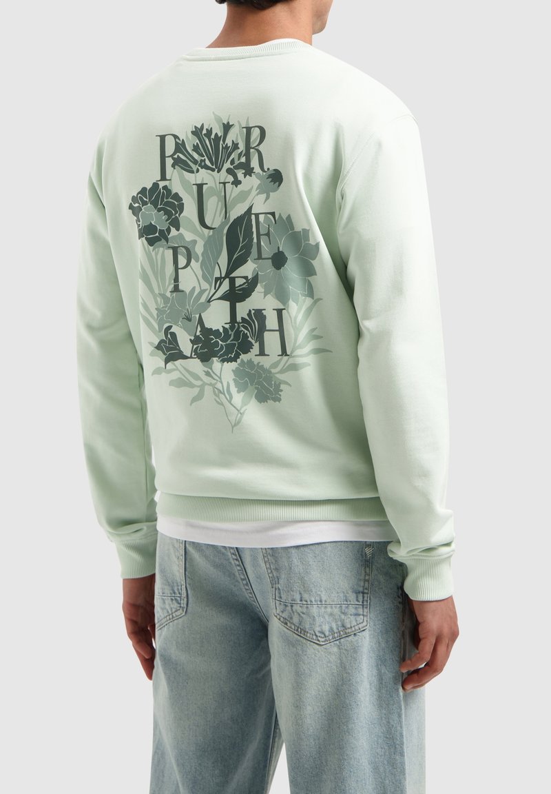 Mintgroene sweatshirt met een bloemen grafisch ontwerp op de achterkant met opdruk, geribbelde manchetten en zoom. Lichte stof met een soepele textuur.