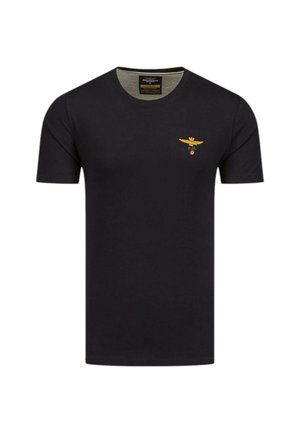 Maglietta nera a maniche corte in cotone, con un piccolo simbolo dorato di un'aquila sul lato sinistro del petto e un design a girocollo.