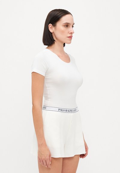 White fitted short-sleeve t-shirt with a scoop neckline paired with white knit shorts featuring a branded waistband. Smooth texture.