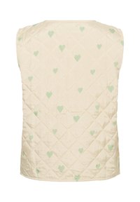 Prsluk s kvadratnim prošivanjem u svijetlo bež boji s dijamantnim uzorkom, koji sadrži male zelene srčeke. Glatka tekstura, bez rukava, s okruglim izrezom.