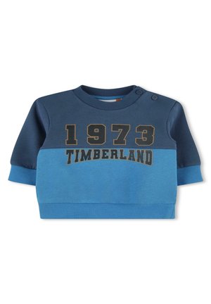Felpa blu e blu scuro con maniche lunghe, polsini a coste, scollo rotondo e "1973 TIMBERLAND" stampato in oro. Due bottoni sulle spalle.