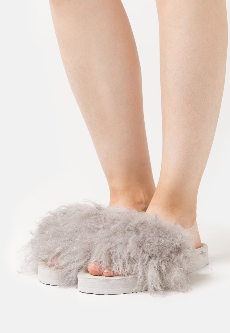 Gray fluffy slide sandals with a thick platform sole, featuring an oversized fur texture and open toe design.