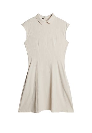 Robe sans manches beige avec des motifs texturés en vagues verticales, une taille cintrée et un petit col, fermée par une fermeture éclair au dos.