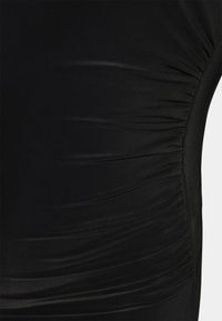 Tecido preto e elástico com detalhes franzidos ao longo do lado, apresentando uma textura suave e um design elegante. Sem hardware ou padrões visíveis.