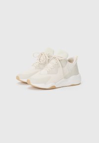 Hvit sneakers med teksturert mesh og glatt lær overdel, med en lysfarget snøring og en gummisåle med en lysbrun aksent.