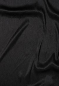 Black textured fabric with fine vertical lines, displaying a smooth, slightly shiny surface and soft drape. Suitable for various textile applications.
