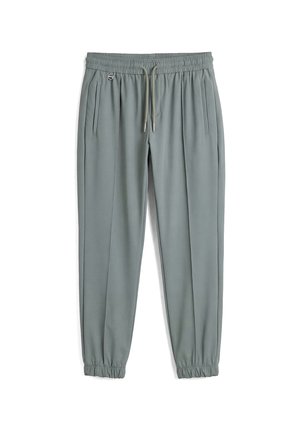 Pantaloni jogger grigio chiaro con gamba affusolata, vita elastica, coulisse, tasche laterali e polsini elastici, mostrati su sfondo bianco.