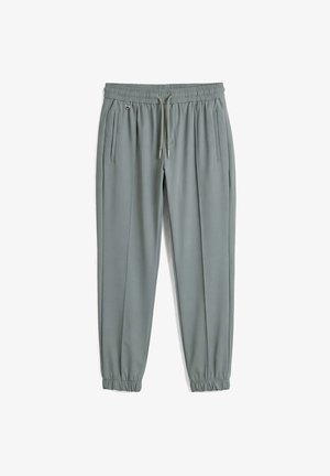 Hellgraue, schmal geschnittene Jogginghosen mit elastischem Bund, Kordelzug, Seitentaschen und elastischen Bündchen, auf weißem Hintergrund dargestellt.