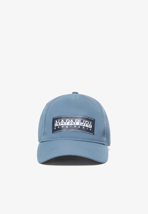 Blauwe pet van glad stof met een rechthoekige voorkant patch met de tekst "NAPAPIJRI geographic" in contrasterende kleuren.